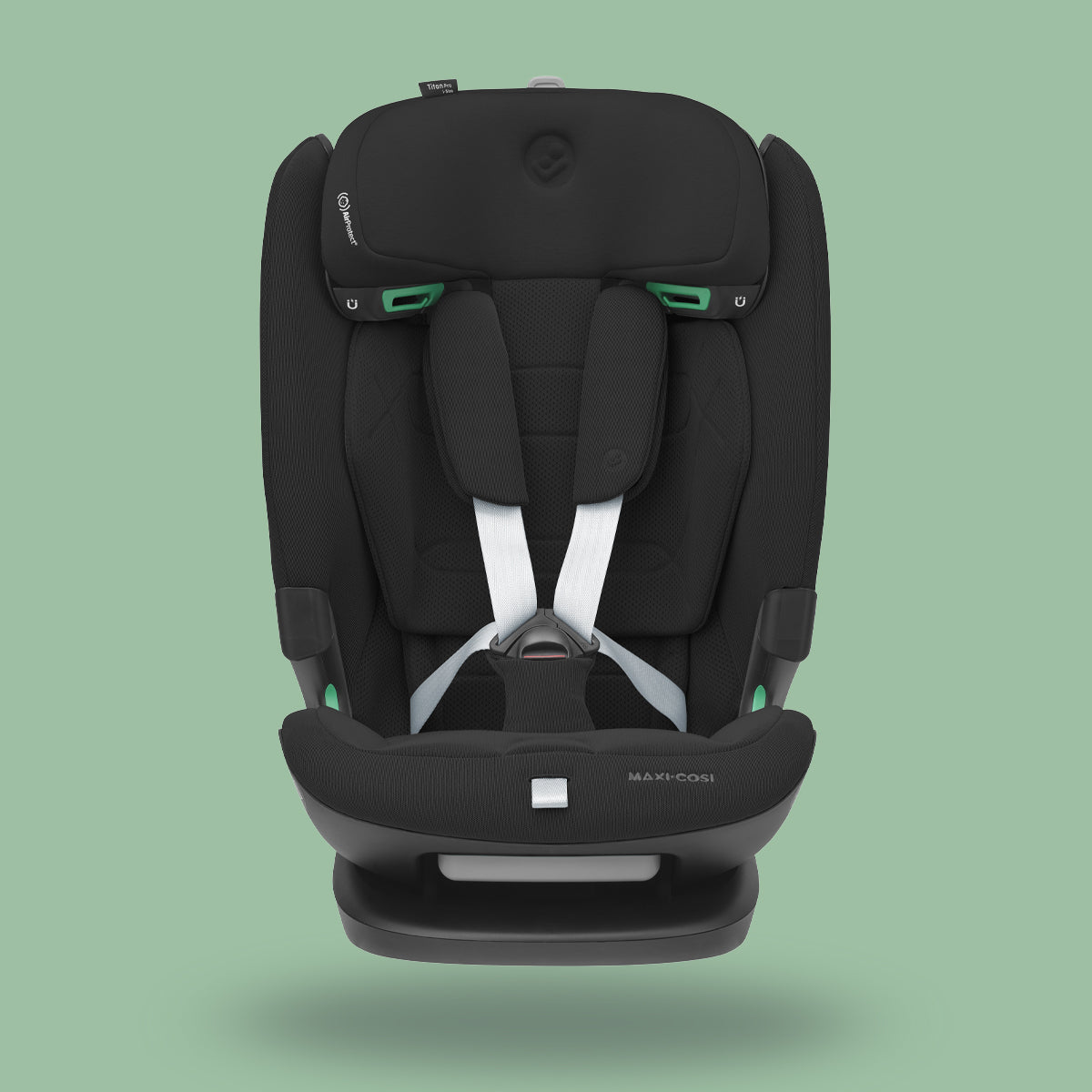 Front view of a black Maxi-Cosi Titan Pro i-Size car seat with white harness straps on a soft green background.