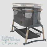 Baby crib with height adjustment features on a light gray background