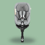 A Maxi-Cosi Mica Pro Eco i-Size baby car seat with a green background.