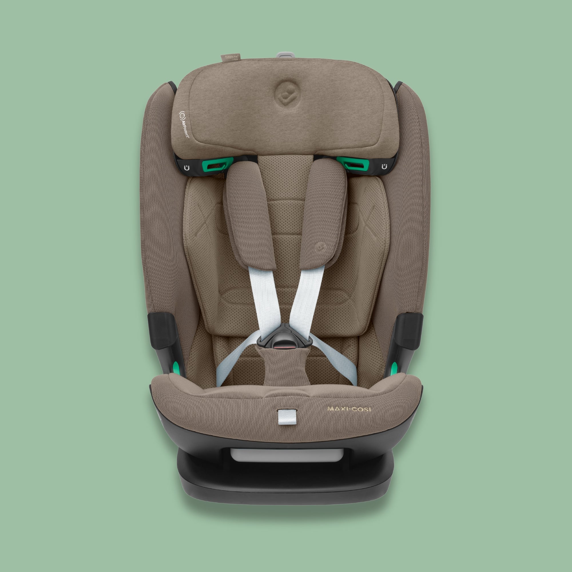 Front view of a truffle brown Maxi-Cosi Titan Pro i-Size car seat with white harness straps on a soft green background.