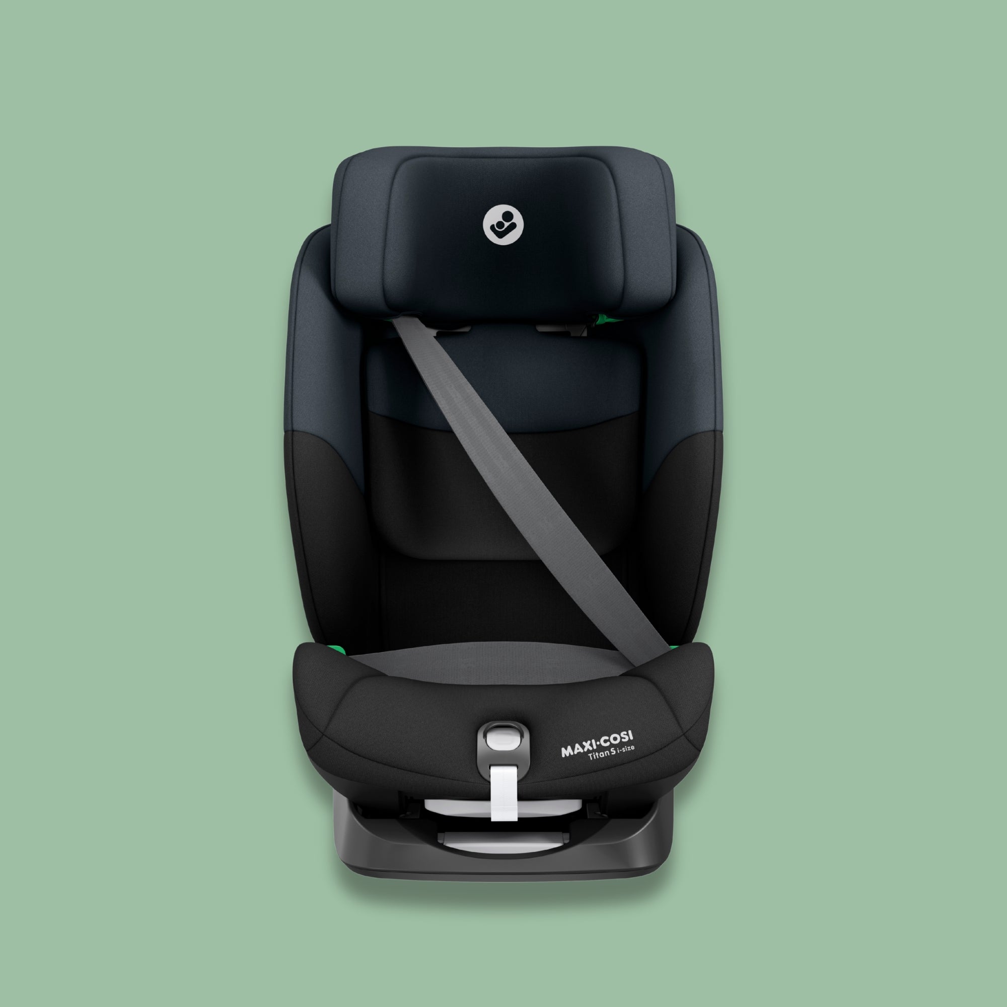 Black Maxi-Cosi car seat on a green background.